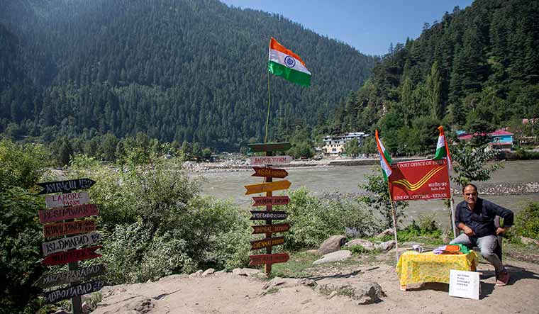 Message of peace: A man near “India's first post office” (the first post office from the LoC) at Keran village on the banks of the Kishanganga | Umer Asif