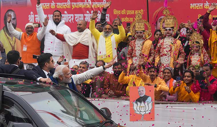 Revival mission: Prime Minister Modi greets the crowd during a roadshow in Ayodhya ahead of the inauguration of a redeveloped railway station and a newly-built airport on December 30, 2023 | PTI
