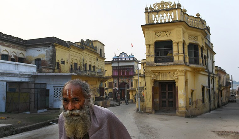 In the name of god: An Ayodhya resident walks past traditional houses near the Sarayu | Bhanu Prakash Chandra