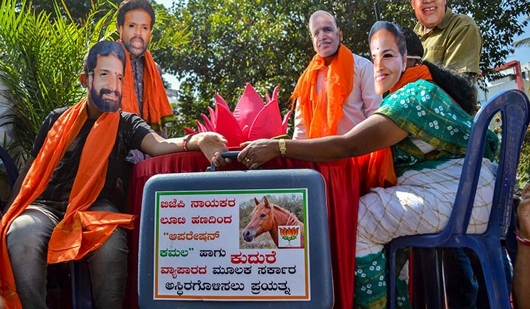 Masked charge: Congress members protest against the BJP’s alleged horse-trading tactics | PTI