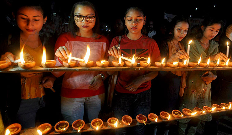 Glowing tribute: Members of the North East Students Organization in Guwahati pay their respects to people who were killed in the anti-Citizenship Bill agitation | PTI