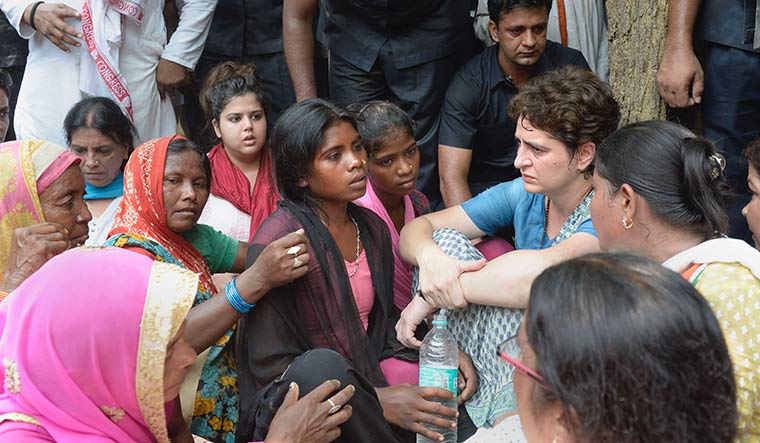 The pain of loss: Priyanka Gandhi consoling family members of the Sonbhadra massacre victims | PTI