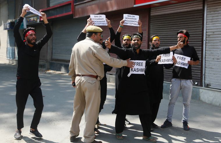 Making peace: A policeman talking to protesters in Kashmir | AP