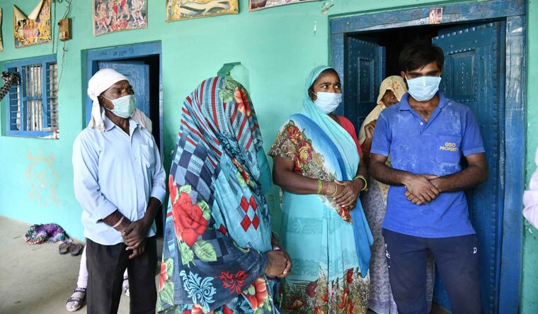 Picture of griefe: The victim’s brother (in T-shirt)and mother (face covered) at home with other relatives | Sanjay Ahlawat