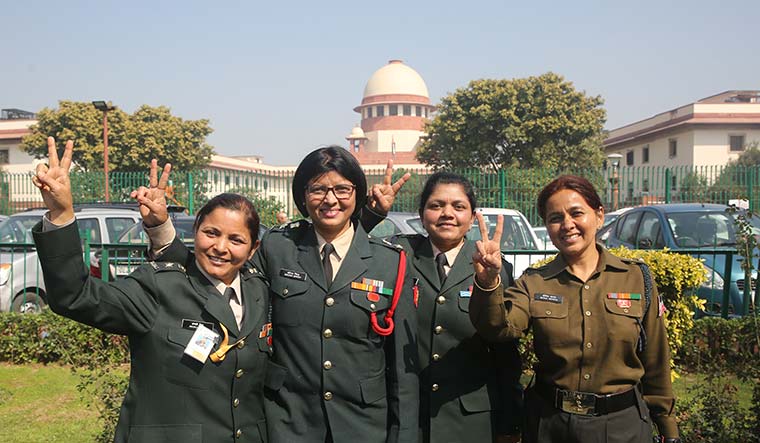 All smiles: Women officers celebrate the Supreme Court verdict in New Delhi.