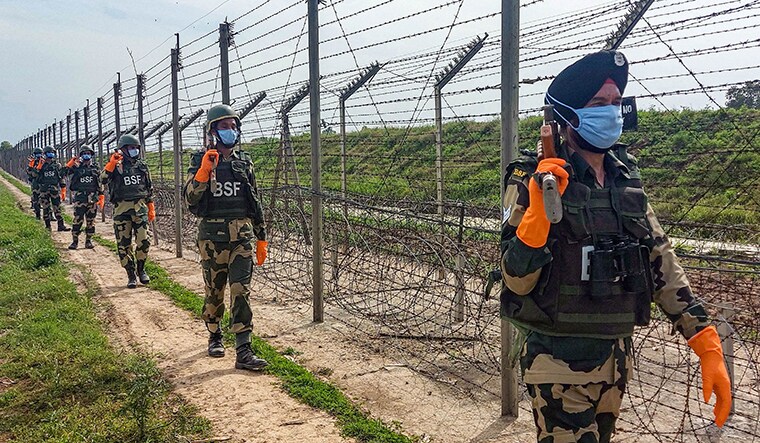 Jammu: Border Security Force (BSF) soldiers wearing masks, in wake of the coronavirus pandemic, patrol along the international border on the outskirts of Jammu, Friday, April 10, 2020. (PTI Photo)(PTI10-04-2020_000238B)
