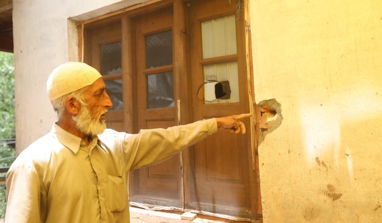 Danger zone: Muhammad Yaqoob Qali of Telawadi village in Uri points to damage caused by shelling | Umer Asif