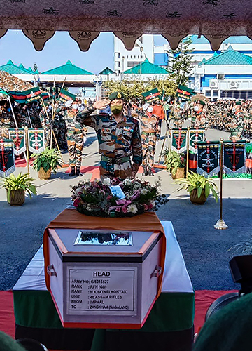 Final salute: An army officer pays homage to his colleagues who were killed in the ambush in Manipur | PTI
