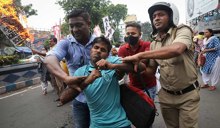 Taking to the streets: Security personnel detain protesters in Kolkata | Reuters