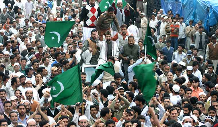 Seat of power: Mirwaiz Umar Farooq greeting people outside the Jamia Masjid in Srinagar in 2009 | Imran Nissar
