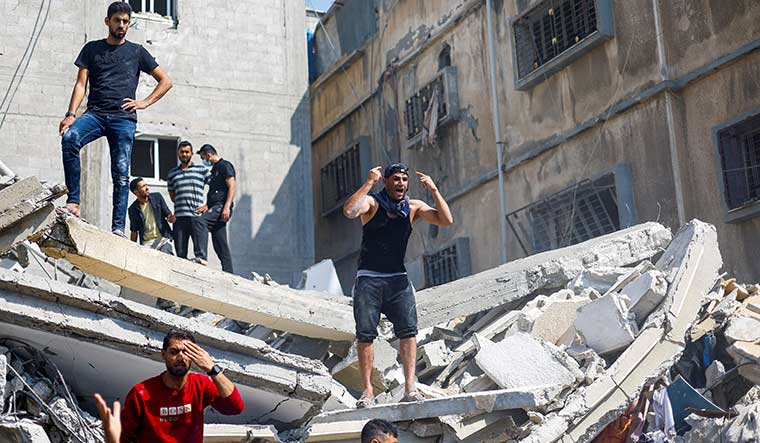 Fight for existence: a man reacts as palestinians gather to search for casualties at the site of an israeli strike at khan younis in southern gaza | Reuters