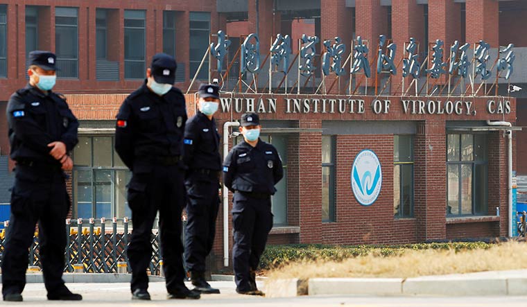 Keeping secrets: File photo of security personnel outside the Wuhan Institute of Virology | Reuters
