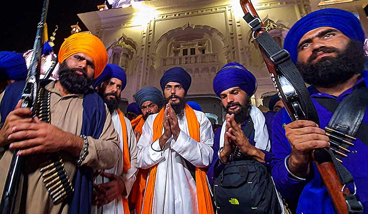 Ready to fire: Amritpal Singh (left) and his associate Lovepreet Toofan offer prayers at the Golden Temple | PTI