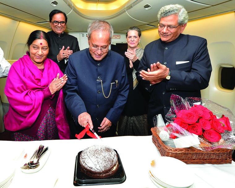 People Person: Mukherjee celebrates his 78th birthday aboard Air India One on his way back to India from South Africa in 2013