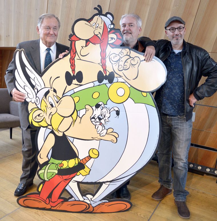 Uderzo (left), who died in March 2020, chose writer Jean-Yves Ferri (in glasses) and illustrator Didier Conrad to continue the series. They made volumes 35-38 under his supervision | AFP