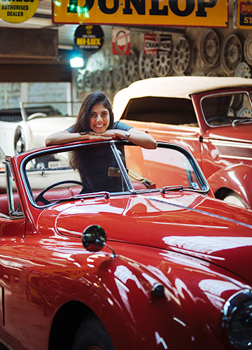 Red hot passion: Rupali Prakash with a car in her collection.