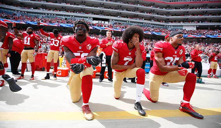 Start of a revolution: Colin Kaepernick (jersey no 7) and two teammates take a knee before an nfl game in 2016 | Getty Images