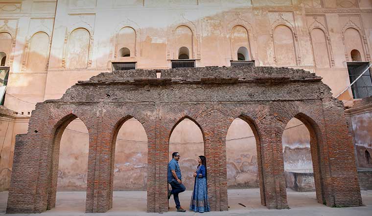 Kiss of life: Syed Mohammed Haider Rizvi, a lawyer, and his wife Sanobar, in front of the restored Sibtainabad Imambara in Lucknow | Pawan Kumar