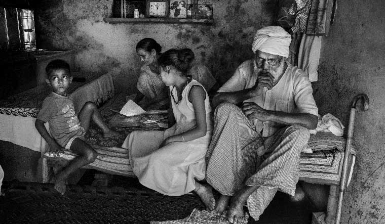 Pain of the past: Noop Kaur, 77, sorts her pre- and post-partition albums, documents and letters alongside her grandchildren and her husband. Kaur was separated from her brother during partition and the two reunited only in 2015.
