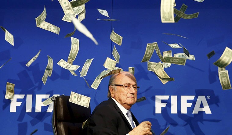 Money ball: Sepp Blatter after banknotes were thrown at him during a news conference amid the 2015 FIFA corruption scandal.