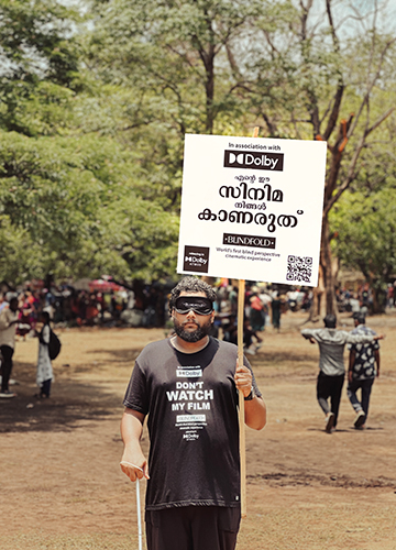Karamen during a promotional campaign for the film. “Do not watch my film,” says the placard.