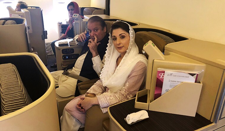 Stormy return: Sharif and Maryam on the Lahore-bound flight from Abu Dhabi on July 13 | Reuters