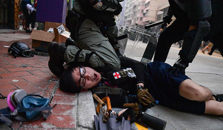 Down, not out: Police detain a protester in the Admiralty area during the October 1 protests. Protesters are facing excessive force, but they are not giving up | AFP
