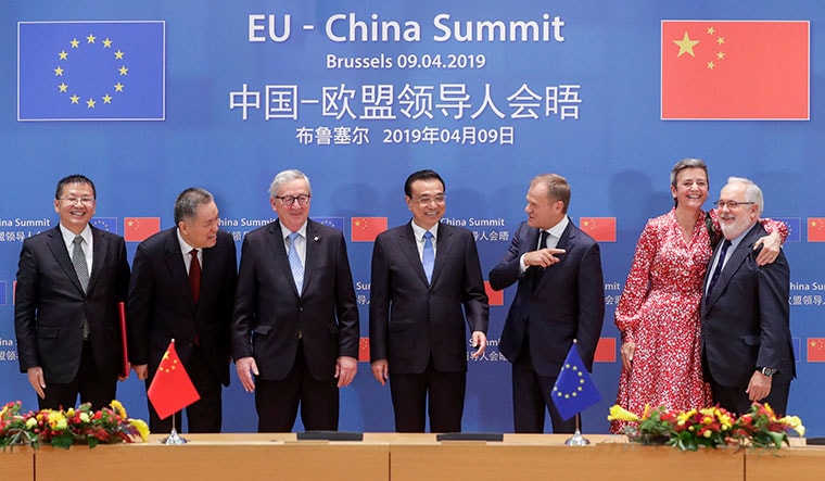 Friends with benefits: Chinese Premier Li Keqiang (centre) at the annual China-EU summit. He is flanked by European Commission President Jean-Claude Juncker (left) and President of the European Council Donald Tusk | AP