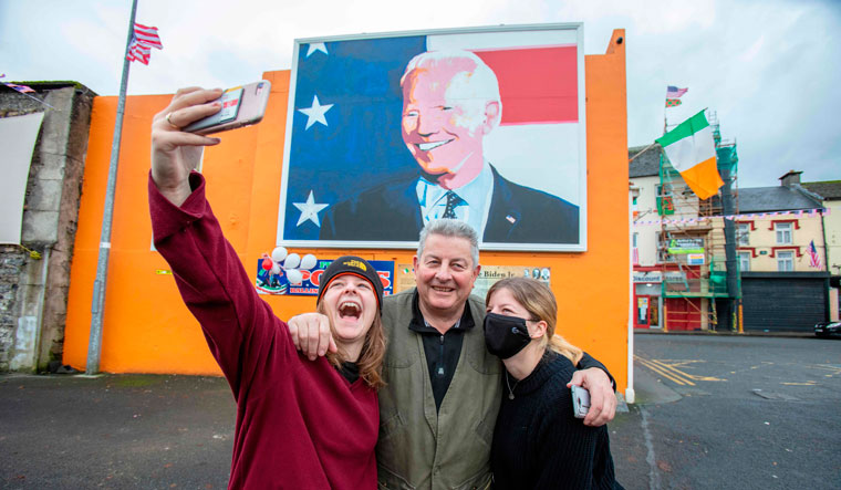 Widening gulf: People take a selfie opposite a poster of joe biden in the us president-elect’s ancestral hometown of Ballina in Ireland. Biden views Brexit as a ‘historical error’ | AFP