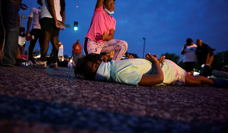 Pushed to the brink: A girl lays on her stomach during a protest against the police brutality in Minneapolis | Reuters