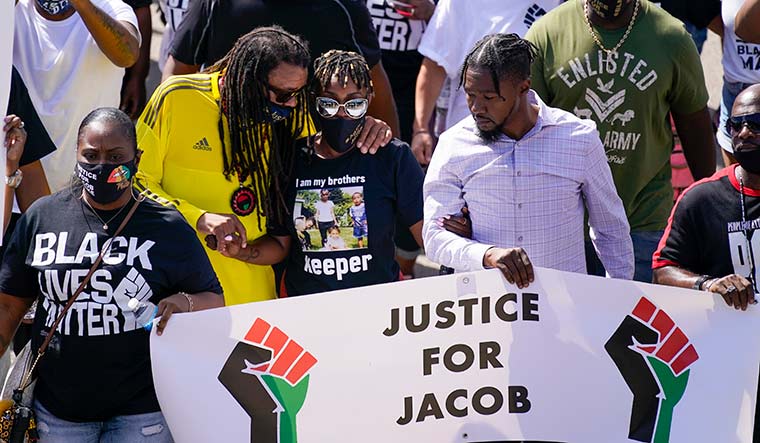 Fighting for justice: Jacob Blake’s sister Letetra Widman (wearing goggles) and uncle Justin Blake (to her right) at a rally in Kenosha on August 29 | AP