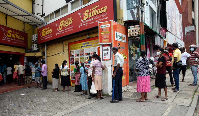 Tough time: People wait outside a supermarket in Colombo to buy essentials | Getty Images