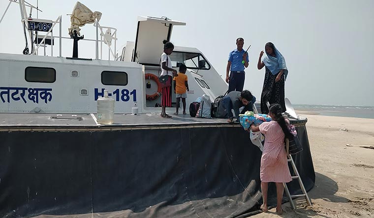 Return to safety: Mary Clary arriving in Dhanushkodi with her newborn, after she was rescued by the Indian Coast Guard.
