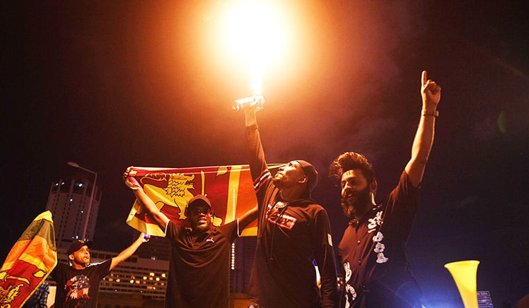 Protesters blow the flame using propane canisters outside the president’s office in Colombo.