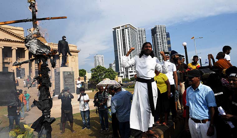 Man of faith, and force: Fr Amila Jeewantha Peiris speaks during a demonstration outside the president’s office in Colombo on July 19 | Bhanu Prakash Chandra