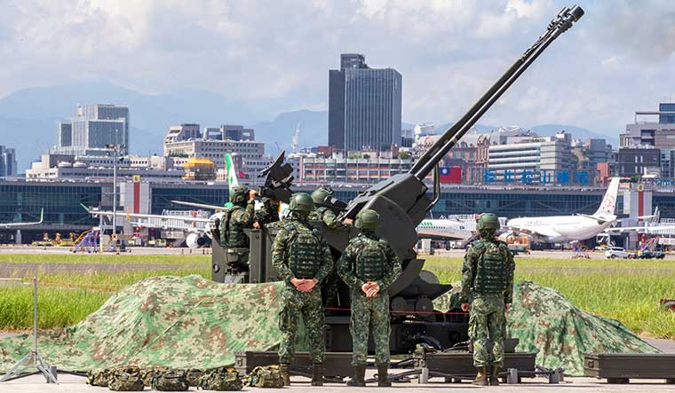 Getting ready: Taiwan Air Force soldiers operate an anti-aircraft gun during a military drill at Taipei Songshan Airport in Taiwan on August 8 | Reuters