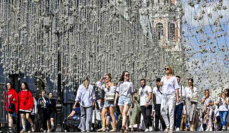 A day out: People near Zaryade Park in Moscow. Life continues as usual in the Russian capital | Getty Images