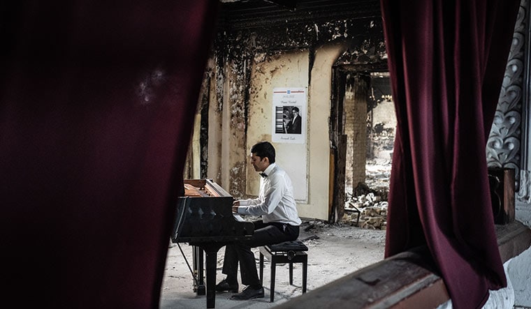 Sorush Zali, an Ukrainian artist, performs the Arno Babajanyan Elegy in a destroyed building in Irpin.
