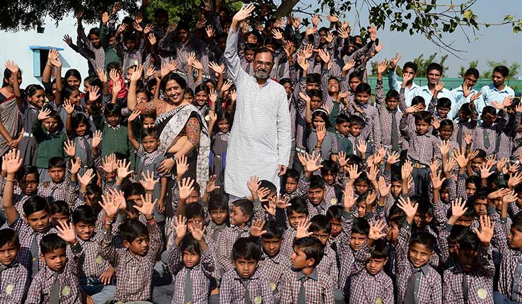 Dedicated duo: Nilesh Desai and his wife, Prakshali, with the children of Buniyadi Shala.