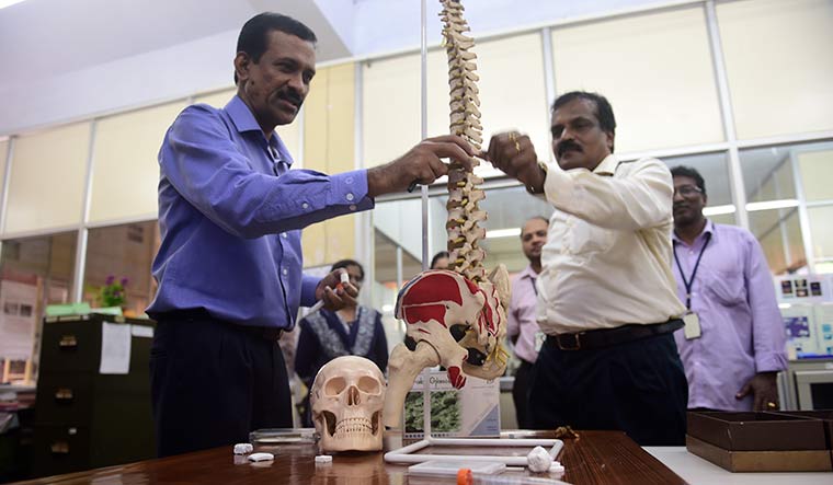 Bone support: Dr Manoj Komath, scientist, looks at the bioceramic beads with Dr P.R. Harikrishna Varma, head, BMT wing.