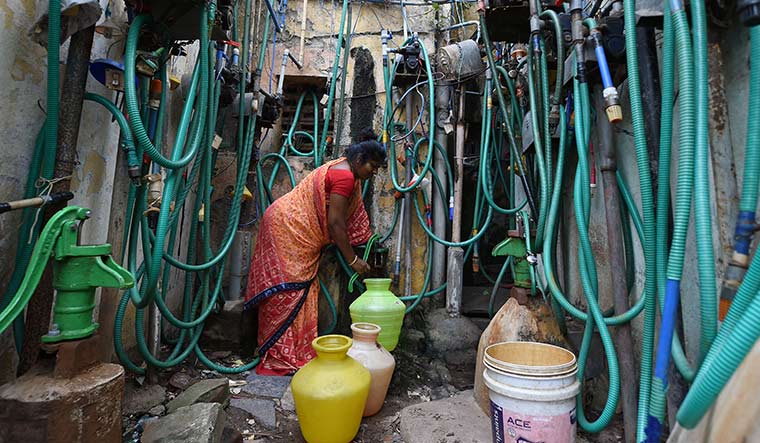 Chennai- A woman fetches water at a housing quarters in north Chennai | R.G. Sasthaa