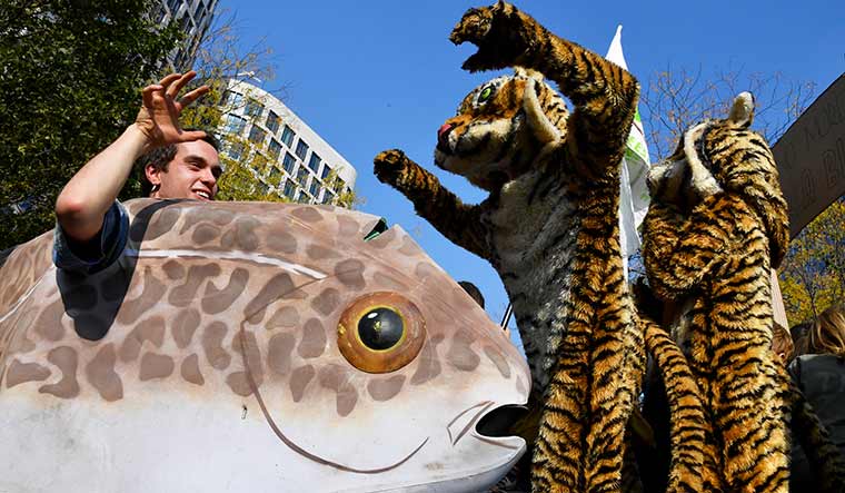 Act for earth: Activists at a climate march held in brussels on october 10.