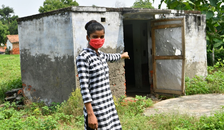 In a shambles: Laxmi points to the toilet at Maa Rampyari Memorial Balika Intermediate College in Harhua, Varanasi | Arvind Jain