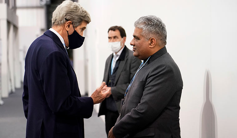 Joint action: US climate envoy John Kerry with Union Minister Bhupender Yadav at the Glasgow summit | AP