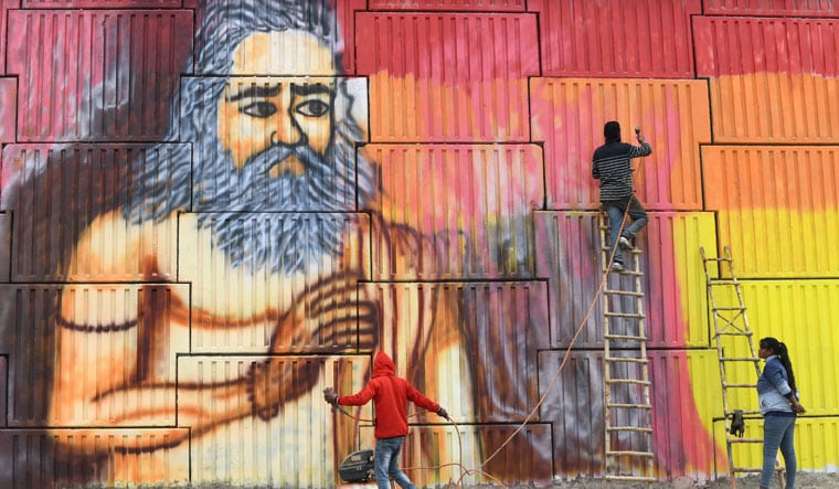 Colour construct: artists paint flyovers with images of sadhus