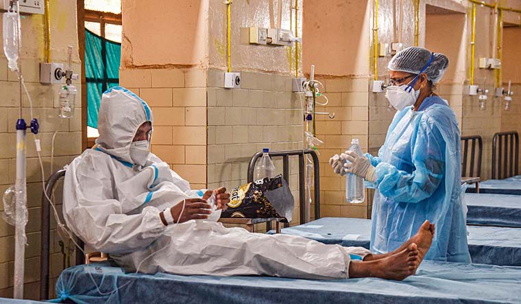 Keeping watch: A health care worker inspects a patient who showed symptoms of monkeypox after returning from abroad at the Government Fever Hospital in Hyderabad | PTI