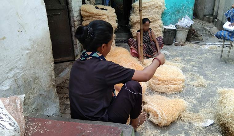 Reclaiming life: Deepti, who was married off at 17, left her abusive husband’s house and now weaves air-cooler panels at her home in Varanasi.
