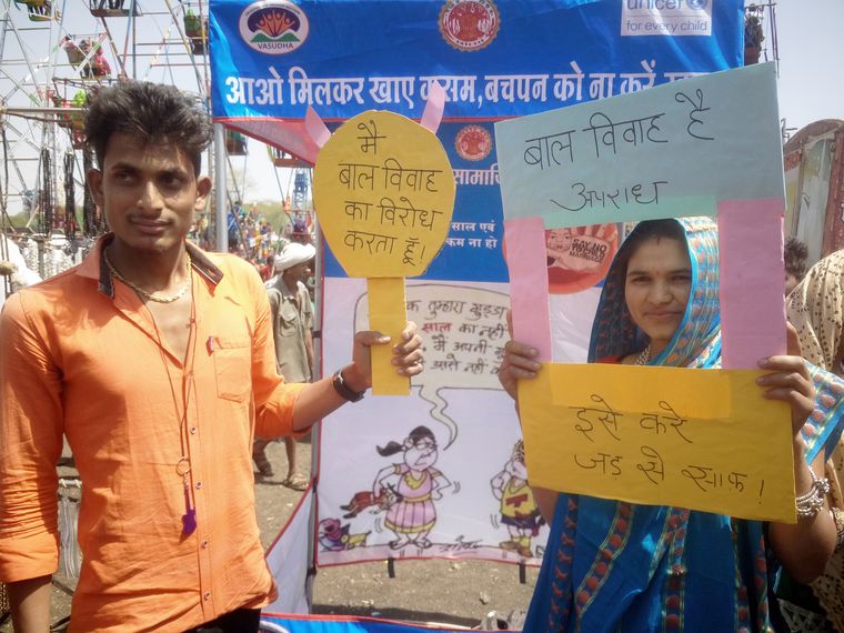 Raising their voice: Tribal youth hold up anti-child marriage placards at a fair in Jhabua, Madhya Pradesh | Sravani Sarkar