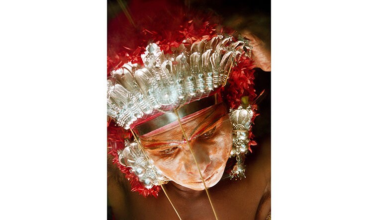 All decked up: A 2002 photograph of a bhoota performer getting ready at the Nemotsava in Koyyuru near Belthangady in Karnataka.