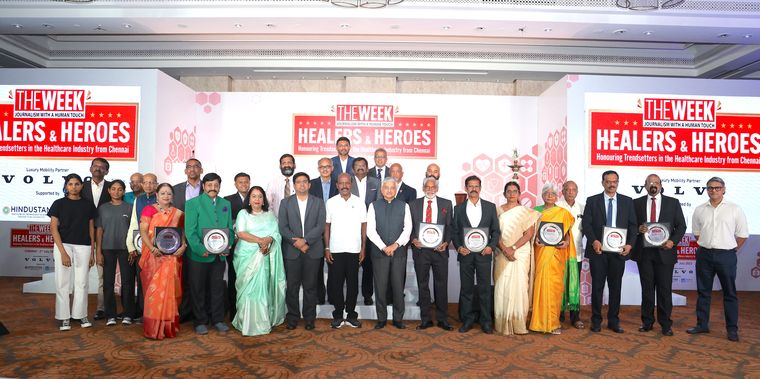 Big salute: Doctors who were felicitated at THE WEEK event in Chennai on July 2, with Tamil Nadu Health Minister Ma Subramanian (in the middle, wearing white shirt), former AIIMS director Dr Randeep Guleria (to his left), Guidance Bureau managing director and CEO V. Vishnu, IAS (to the minister’s right), and THE WEEK’s Chief Associate Editor and Director Riyad Mathew (extreme right) | R.G. Sasthaa